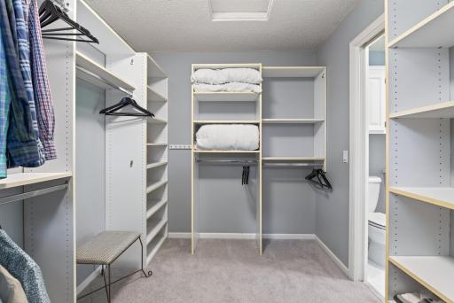 Thoughtfully designed custom built-ins create a beautifully organized dressing space.