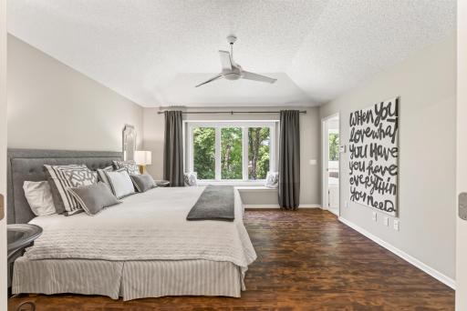 Spacious and conveniently located on the main level, the primary suite offers comfort, privacy, and peaceful backyard views.