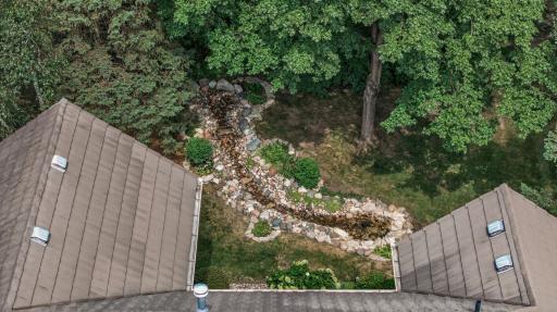 A bird's-eye view showcases the exceptional lot, beautiful landscaping, and thoughtfully designed outdoor living spaces.