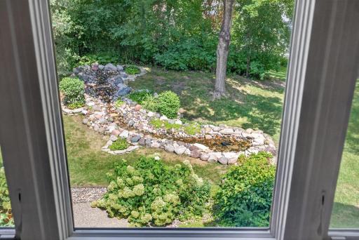 Wake each morning to peaceful views overlooking the backyard waterfall.
