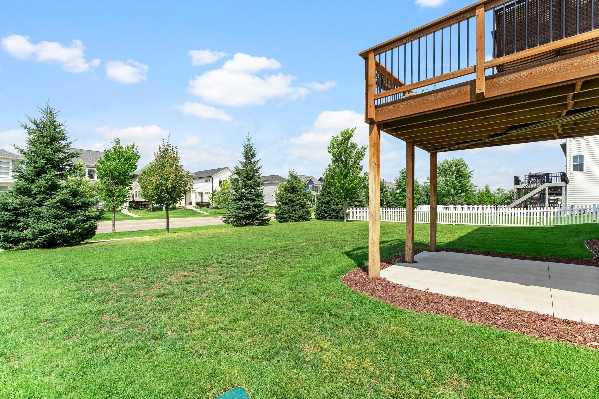 The backyard features numerous planted pine trees that will continue to mature, creating even more privacy and a peaceful buffer from the road