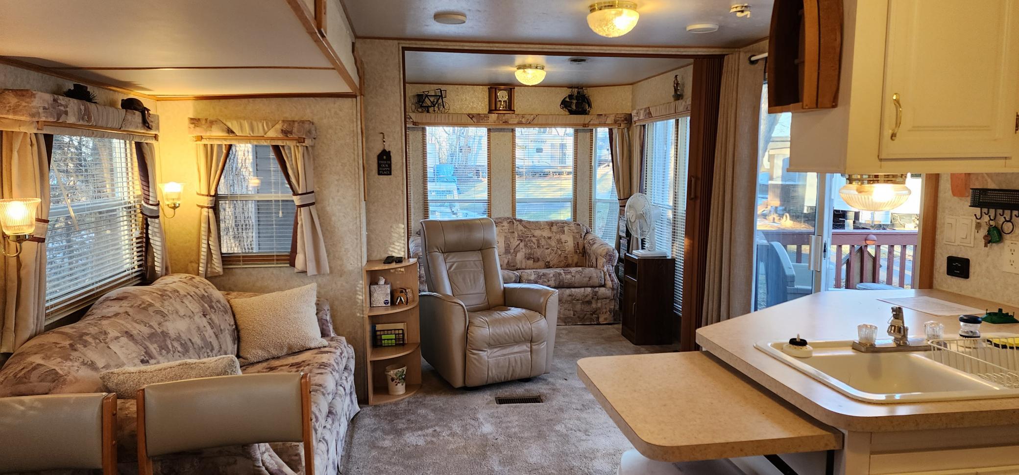 Inside includes a living room and den area with divider you can use for a private bedroom.