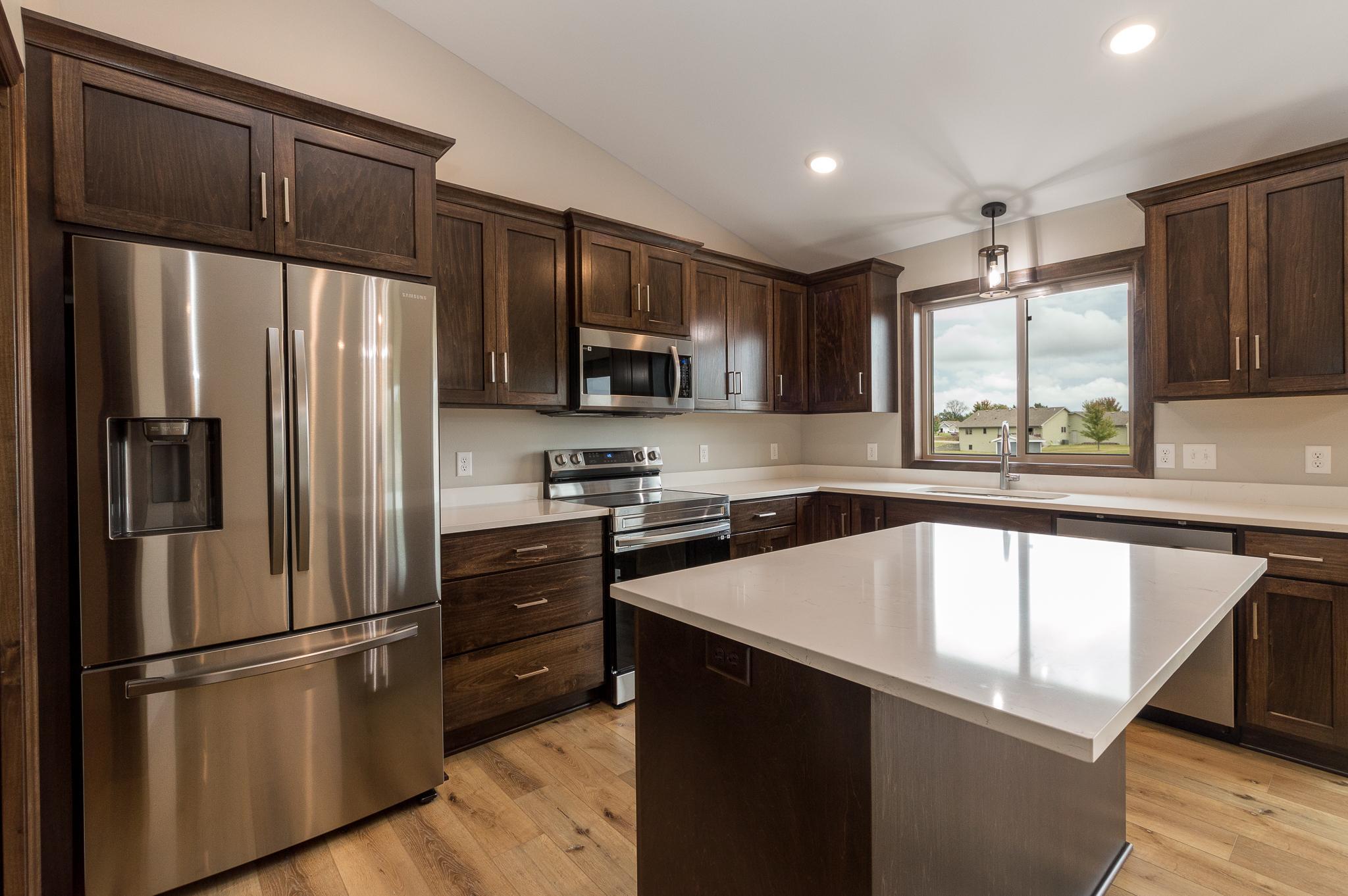 Custom built cabinets with ample storage, pantry and beautiful countertops