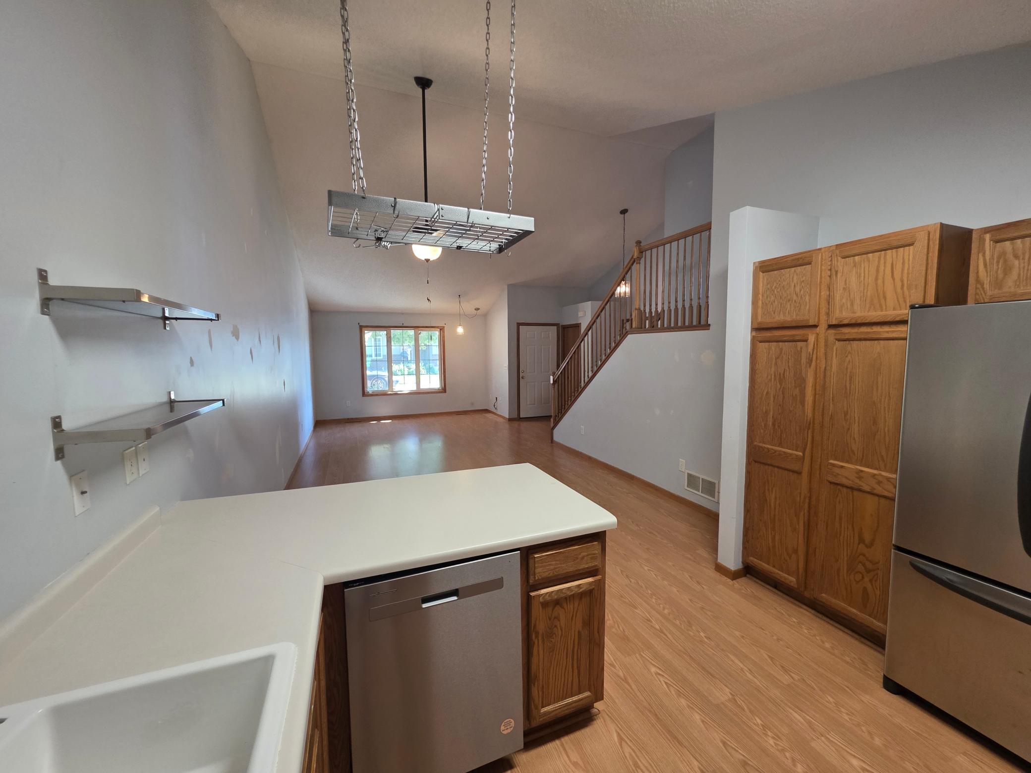 Kitchen view overlooking the open living area, with stainless-steel appliances and generous workspace.