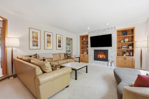 The living room features a stunning floor-to-ceiling tile gas fireplace.