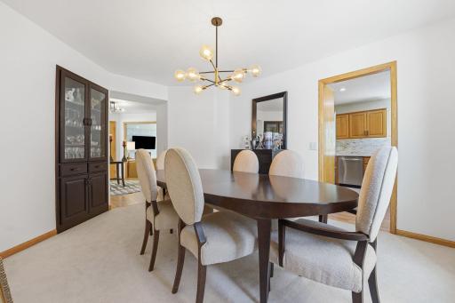 The formal dining room is located off the kitchen and has new carpet.