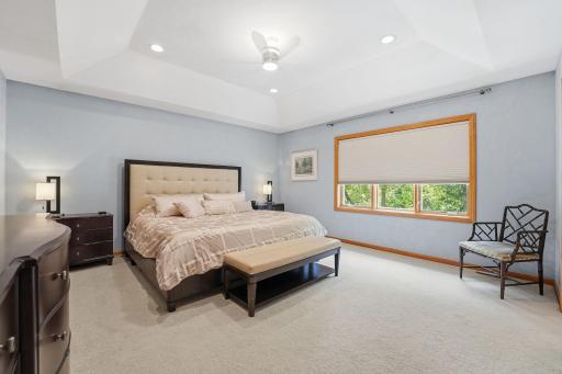 Head upstairs to the primary bedroom, which features a coffered ceiling, 2 separate walk-in closets, and a new window.