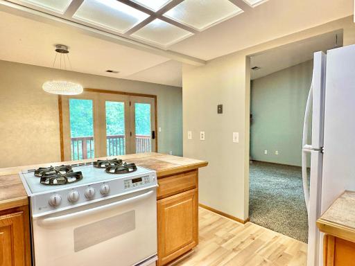 Three patio doors bring in great natural light to both the kitchen and living room.