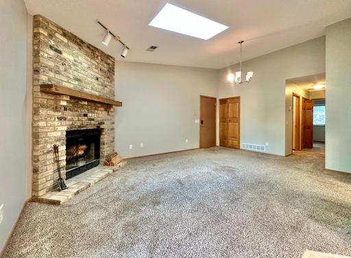 Entry door and coat closet in back. The living room is roomy and warm with the wood burning fireplace. All walls and ceiling have been just painted and carpets shampooed!