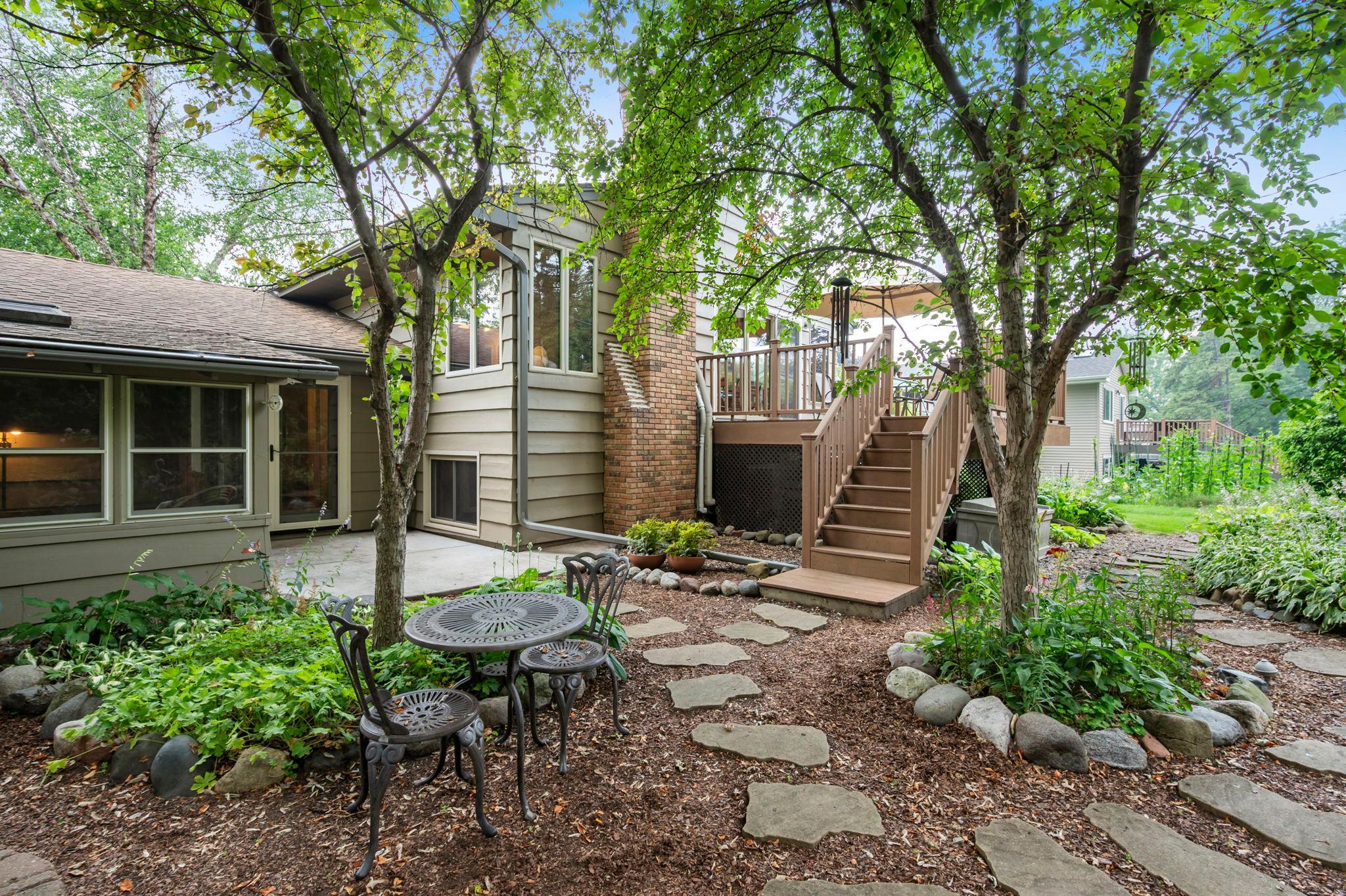 Deck, back patio, 3 season porch, burning pit, water pond.