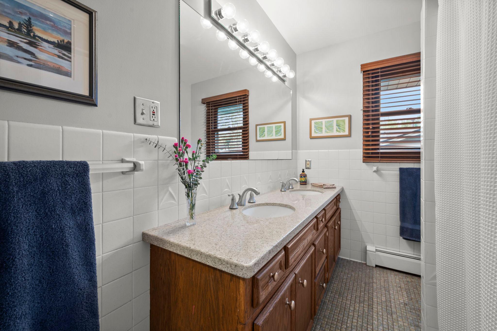 Full bath with double vanity and tiled floor