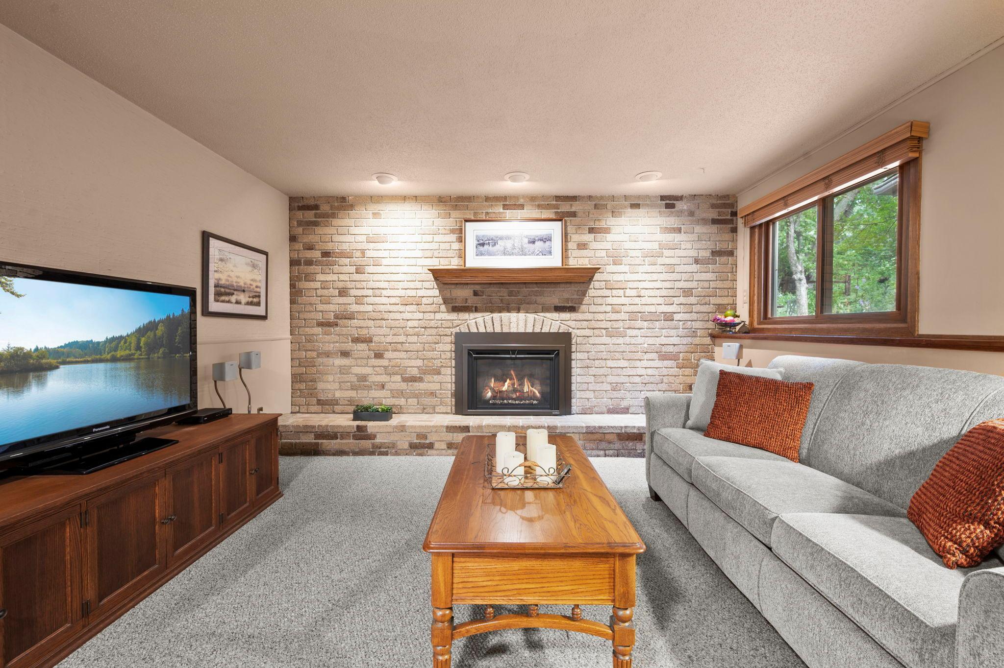 Cozy lower level family room with gas fireplace