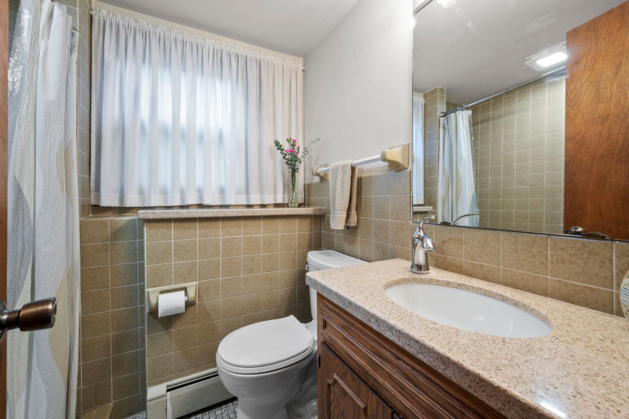 Lower level 3/4 bath with tiled shower and floor