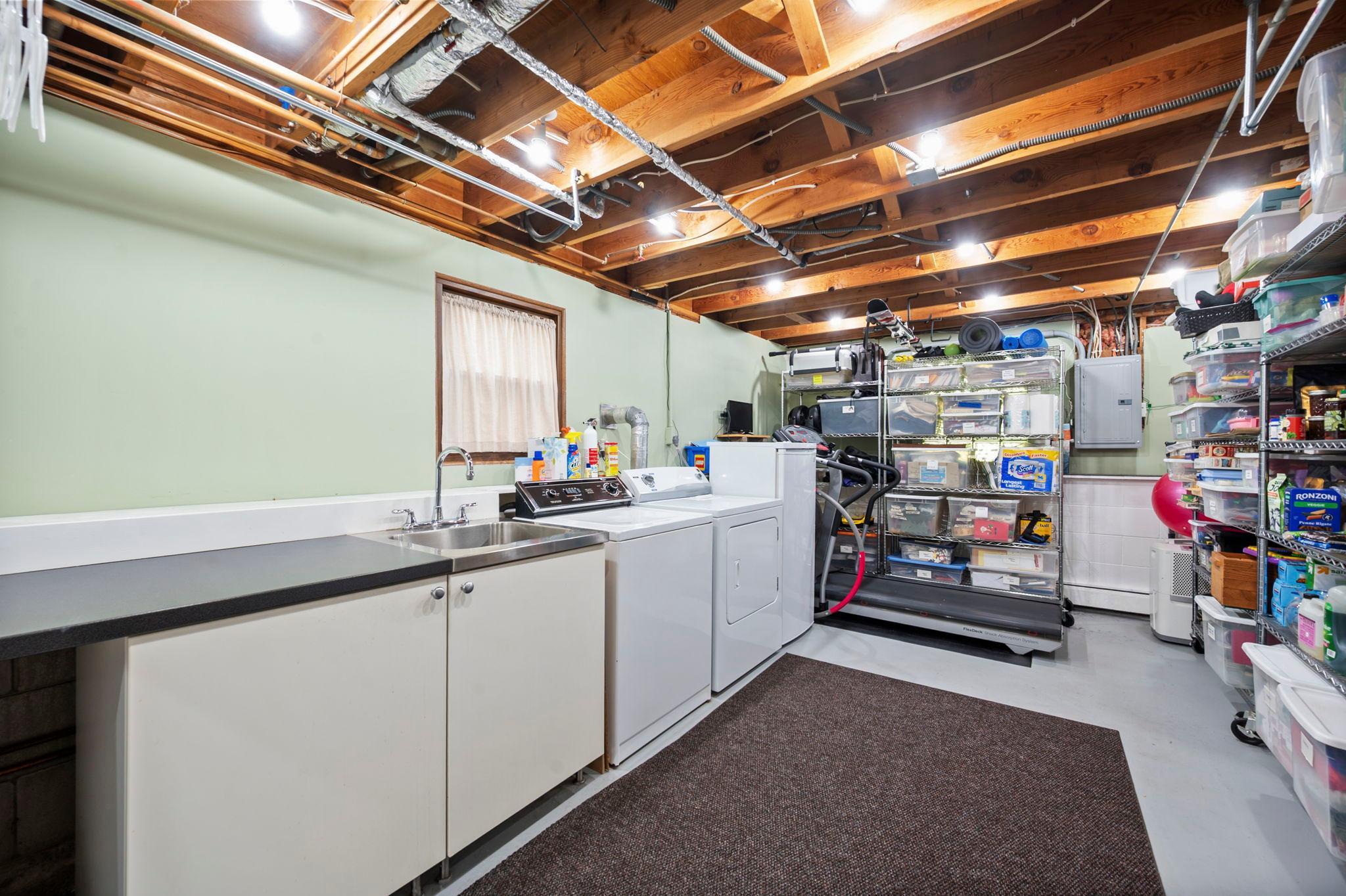 large laundery room with wash tub and counter space