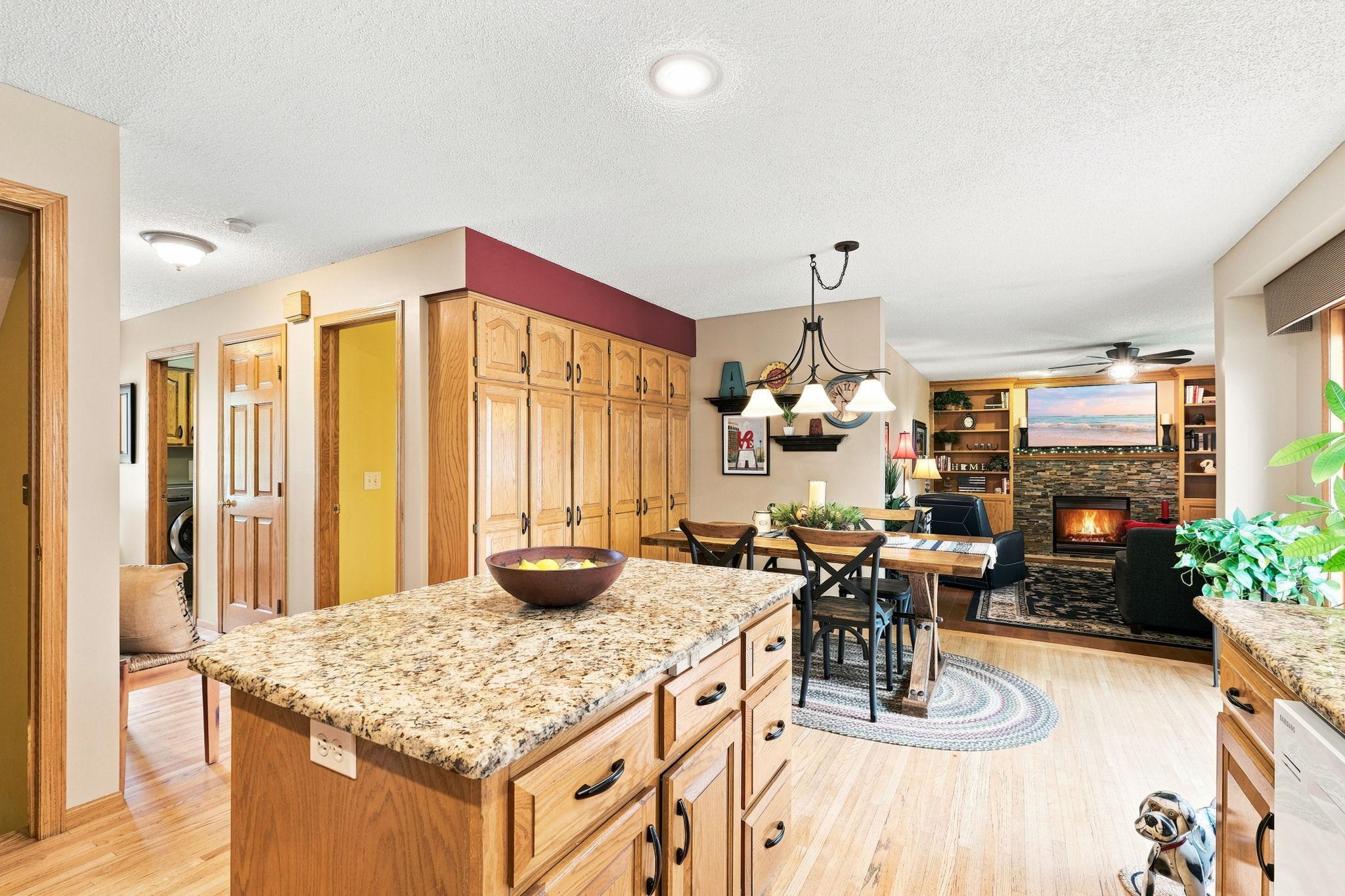 Kitchen has beautiful oak floors and granite counters, and eat-in dining with a large pantry cabinet.