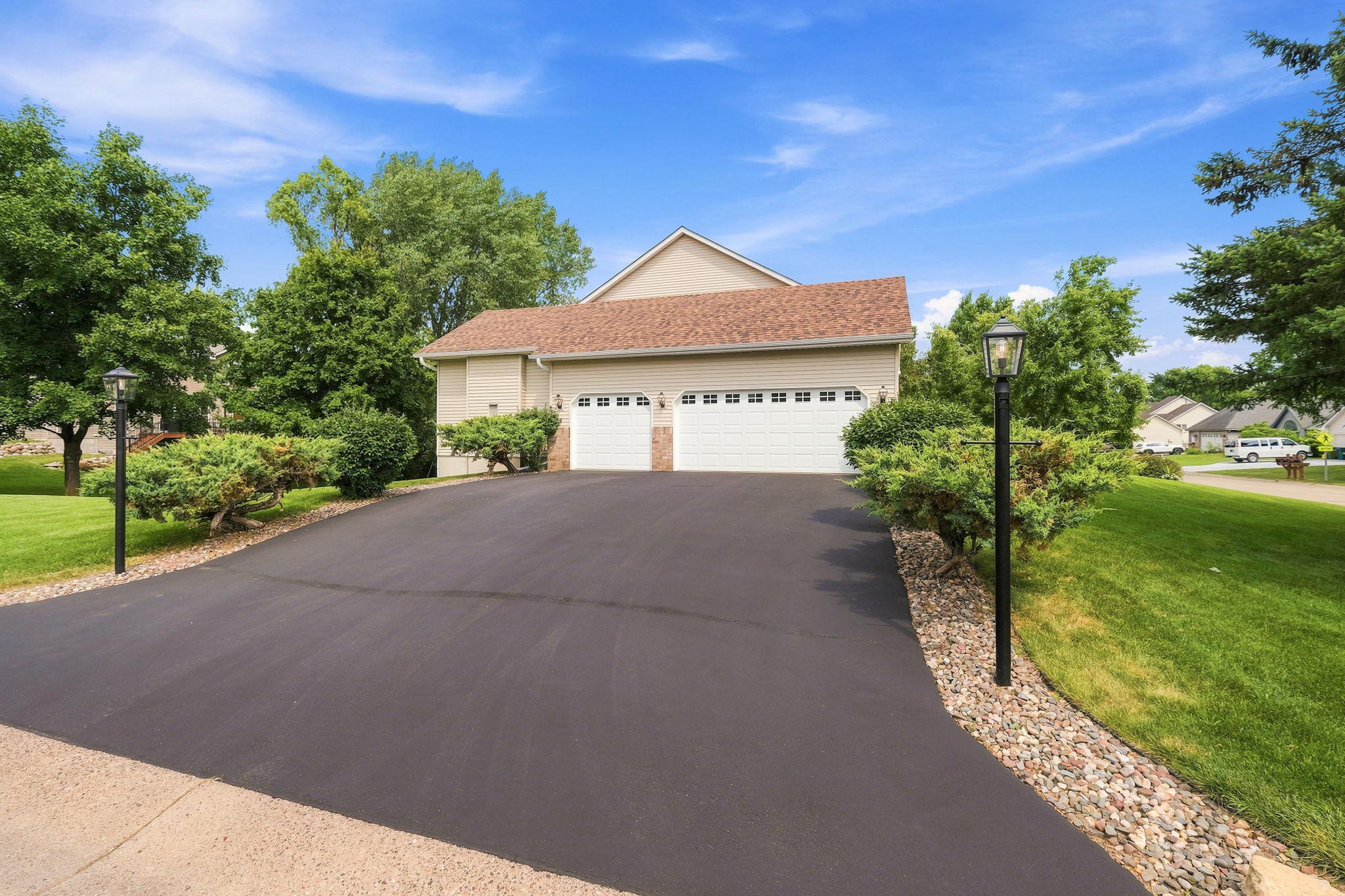 Newly refinished driveway and brand new garage doors.