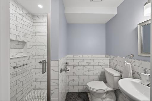 Lower level 3/4 bath with beautiful tile work