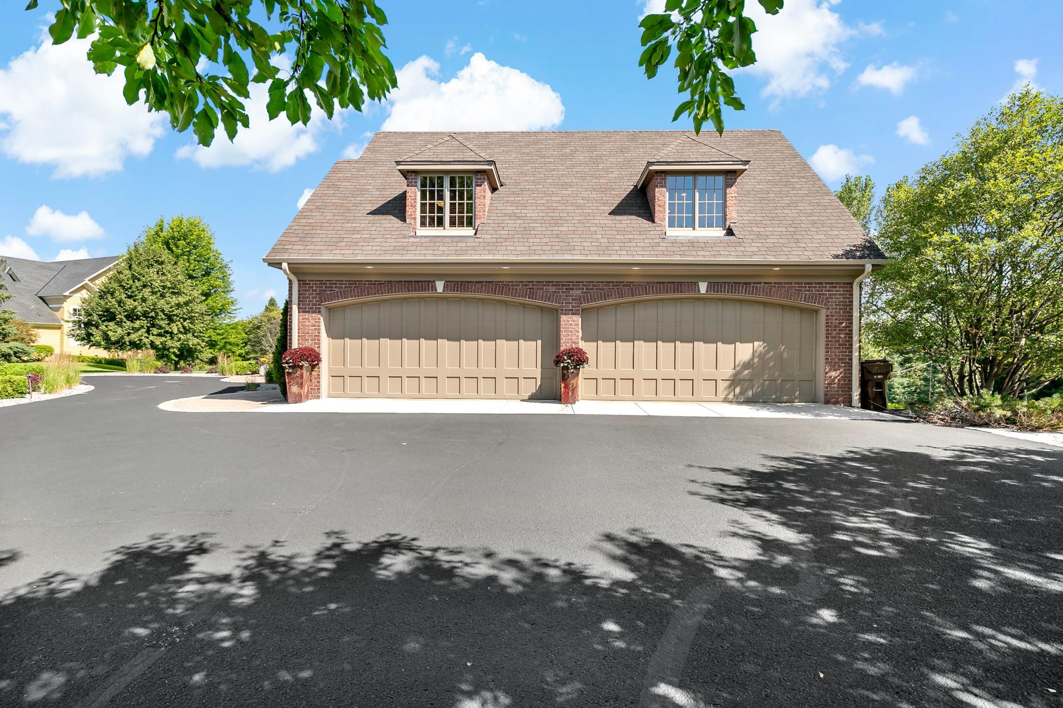4 car spacious garage, Timeless all-brick construction, maintenance-free exterior, and premium 50-year shingles provide lasting beauty and peace of mind.