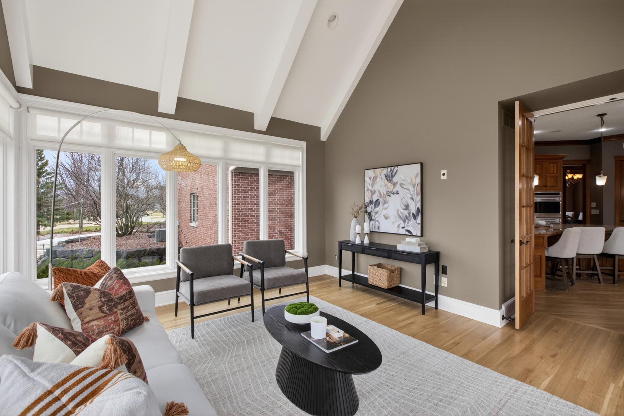 The sunroom offers panoramic backyard views through upgraded windows, creating one of the home's most peaceful gathering spaces.