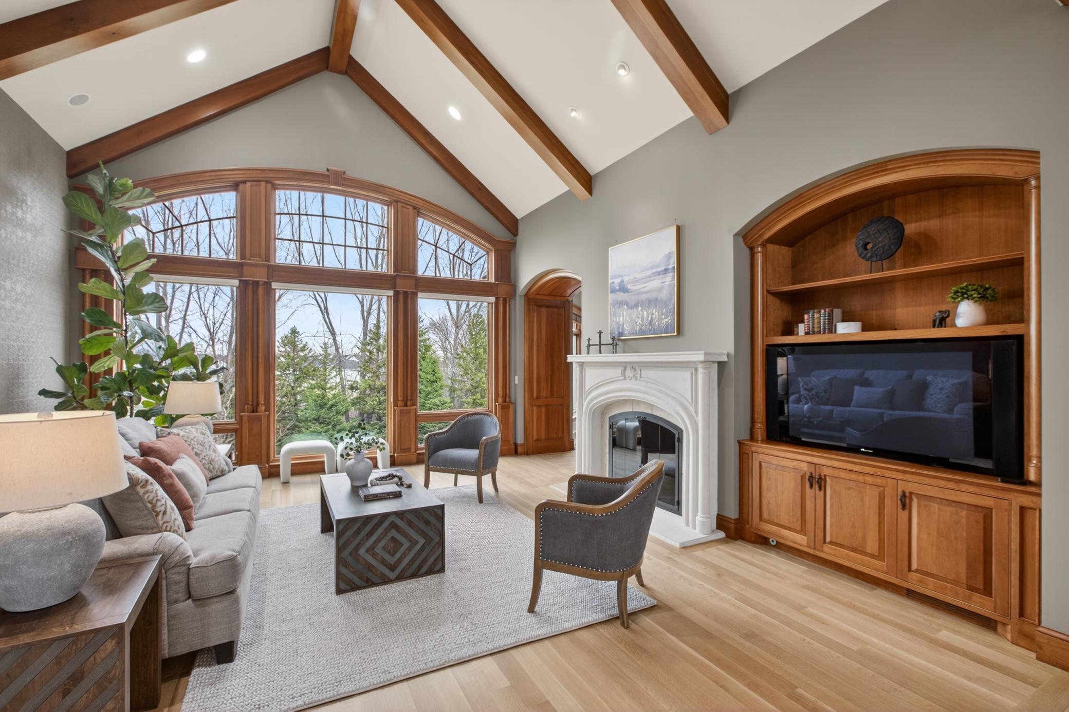 A soaring vaulted ceiling and walls of windows fill the great room with natural light while showcasing beautiful views of the private 1.4-acre homesite.