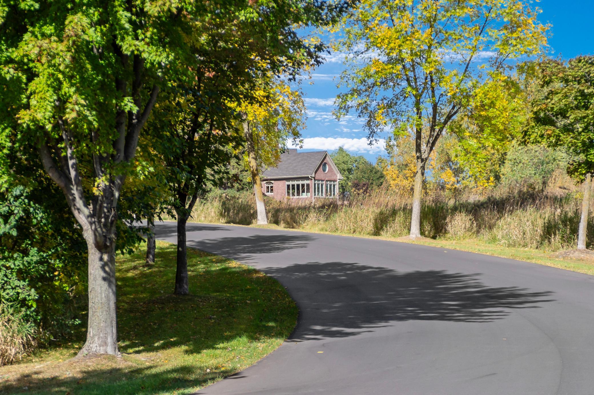 Surrounded by mature trees and beautifully landscaped grounds, the private backyard creates a peaceful retreat just minutes from the downtown Wayzata.