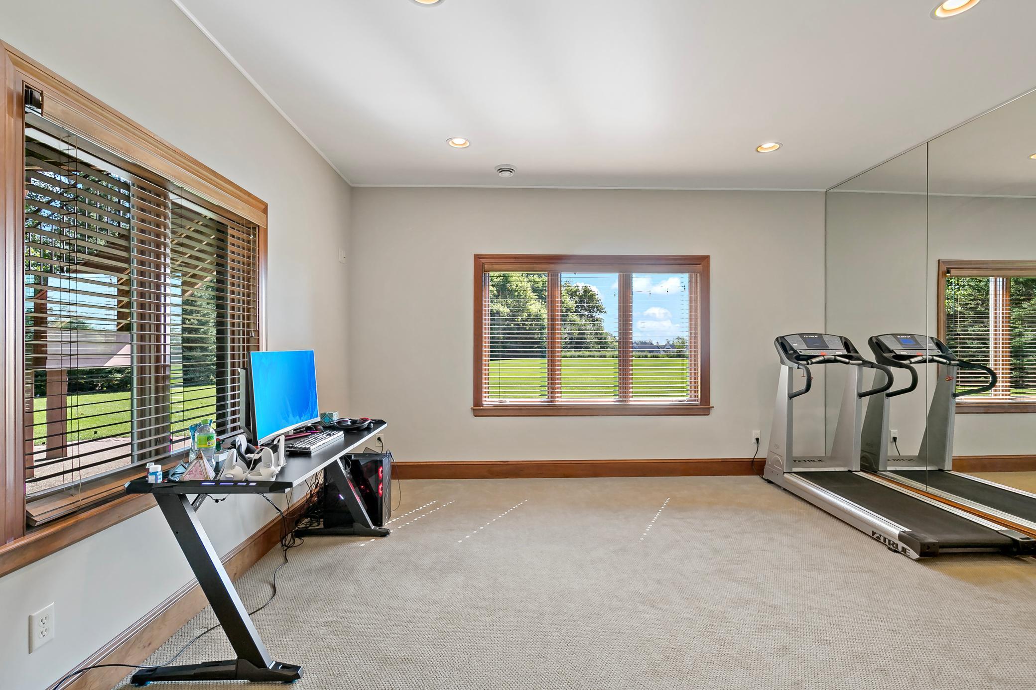 Versatile lower-level bedrooms with large windows and generous space create endless possibilities for private offices, a home gym, guest suites, or multigenerational living.