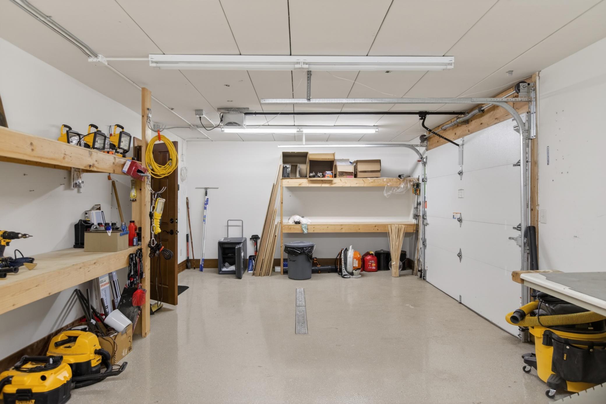 Rare heated workshop featuring a floor drain and direct backyard access, creating the ideal space for woodworking, DIY projects, equipment storage, or a home workshop.