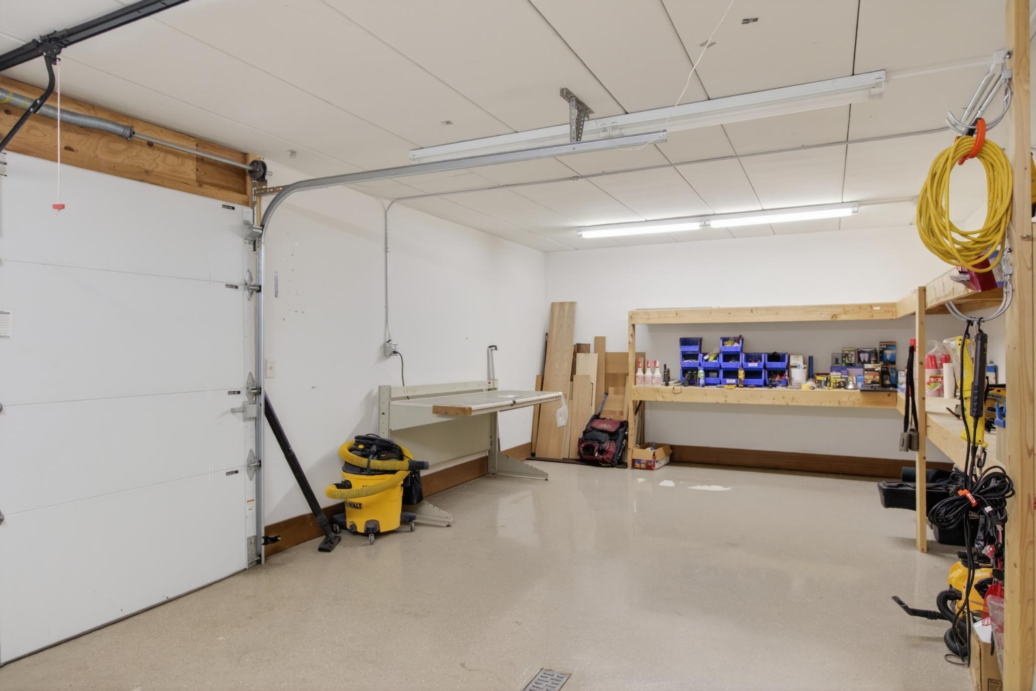 Heated tuck-under workshop with floor drain and convenient backyard access—perfect for projects, hobbies, storage, or year-round workspace.