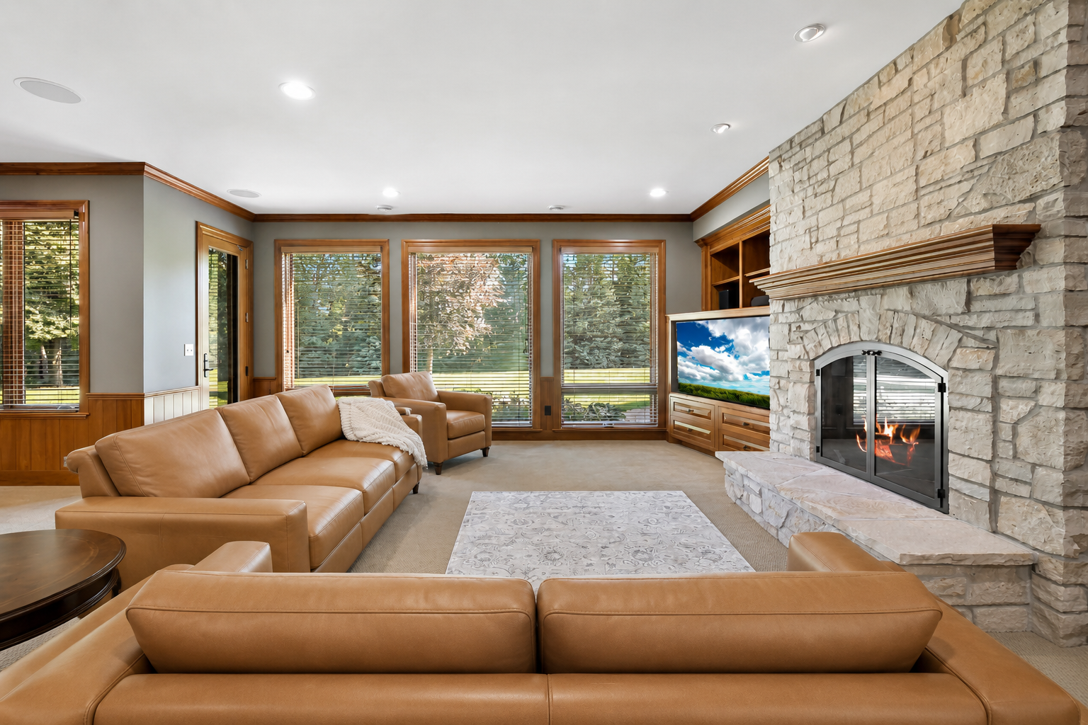 Resort-inspired walkout lower level with a full wet bar, game area, and impressive stone accents for effortless entertaining.
