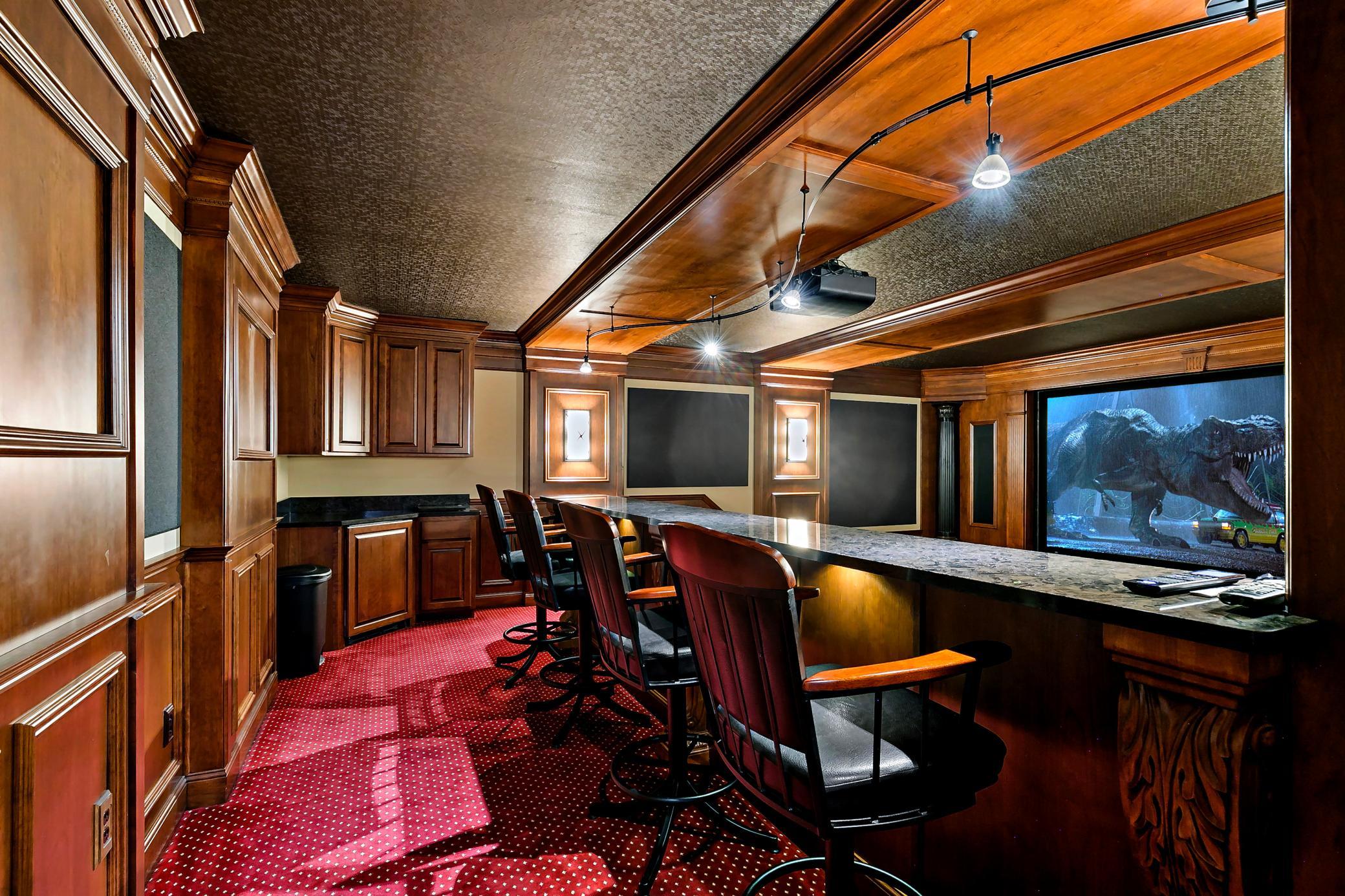 Experience true cinematic luxury in the custom home theater, prewired to accommodate three additional screens for unforgettable game-day viewing.