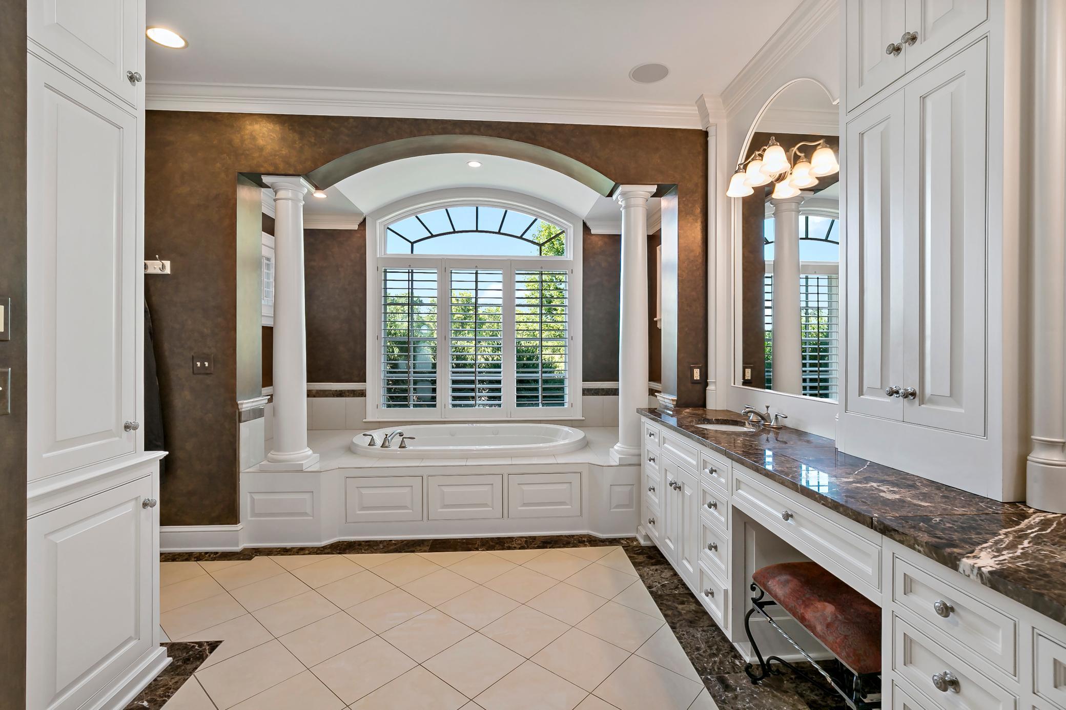 Spacious primary en suite completes the main-floor owner's retreat, creating a private sanctuary without stairs.