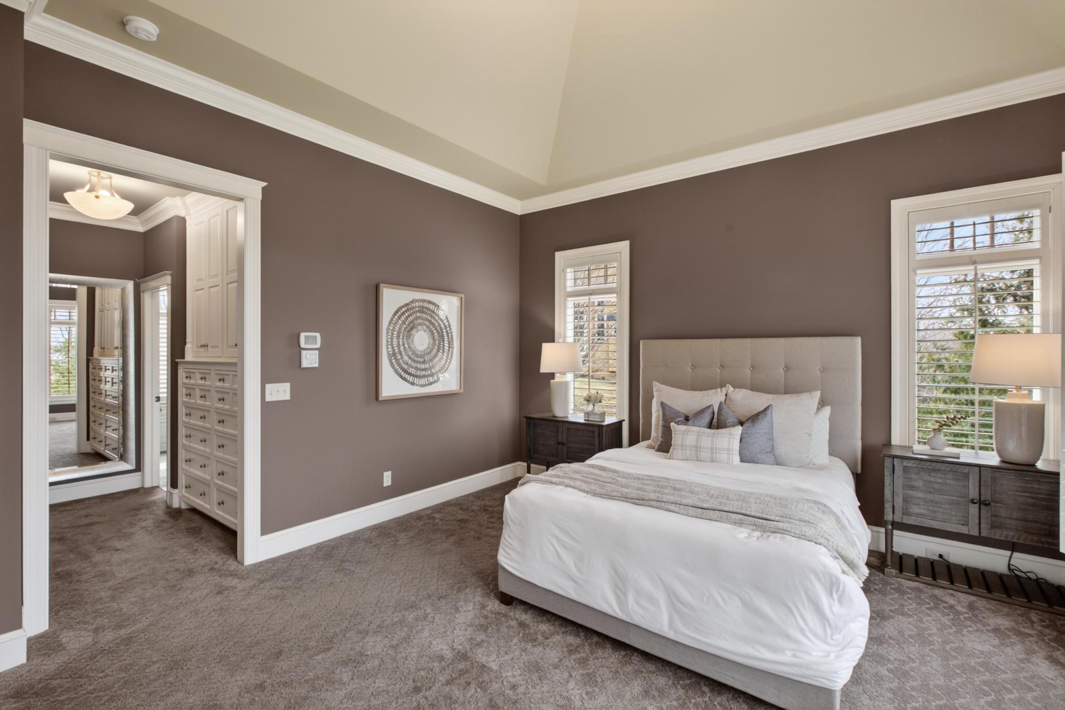 Main-floor primary suite offers the comfort and accessibility today's luxury buyers are searching for in an executive rambler.