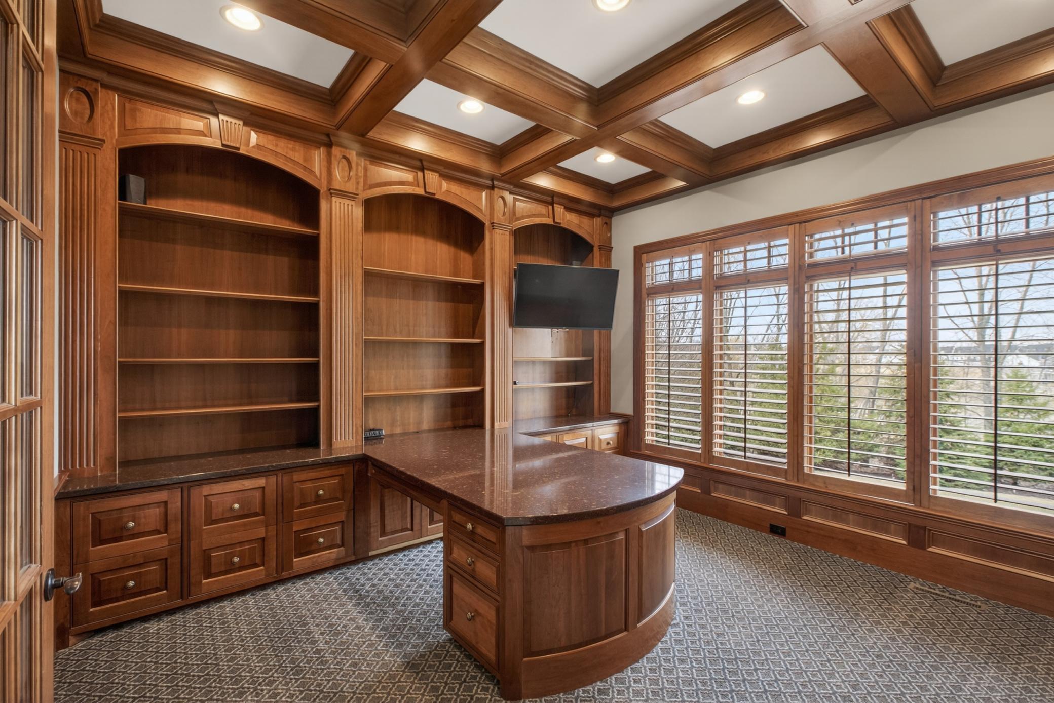 Dedicated work-from-home office featuring custom floor-to-ceiling cherry cabinetry and exceptional craftsmanship.