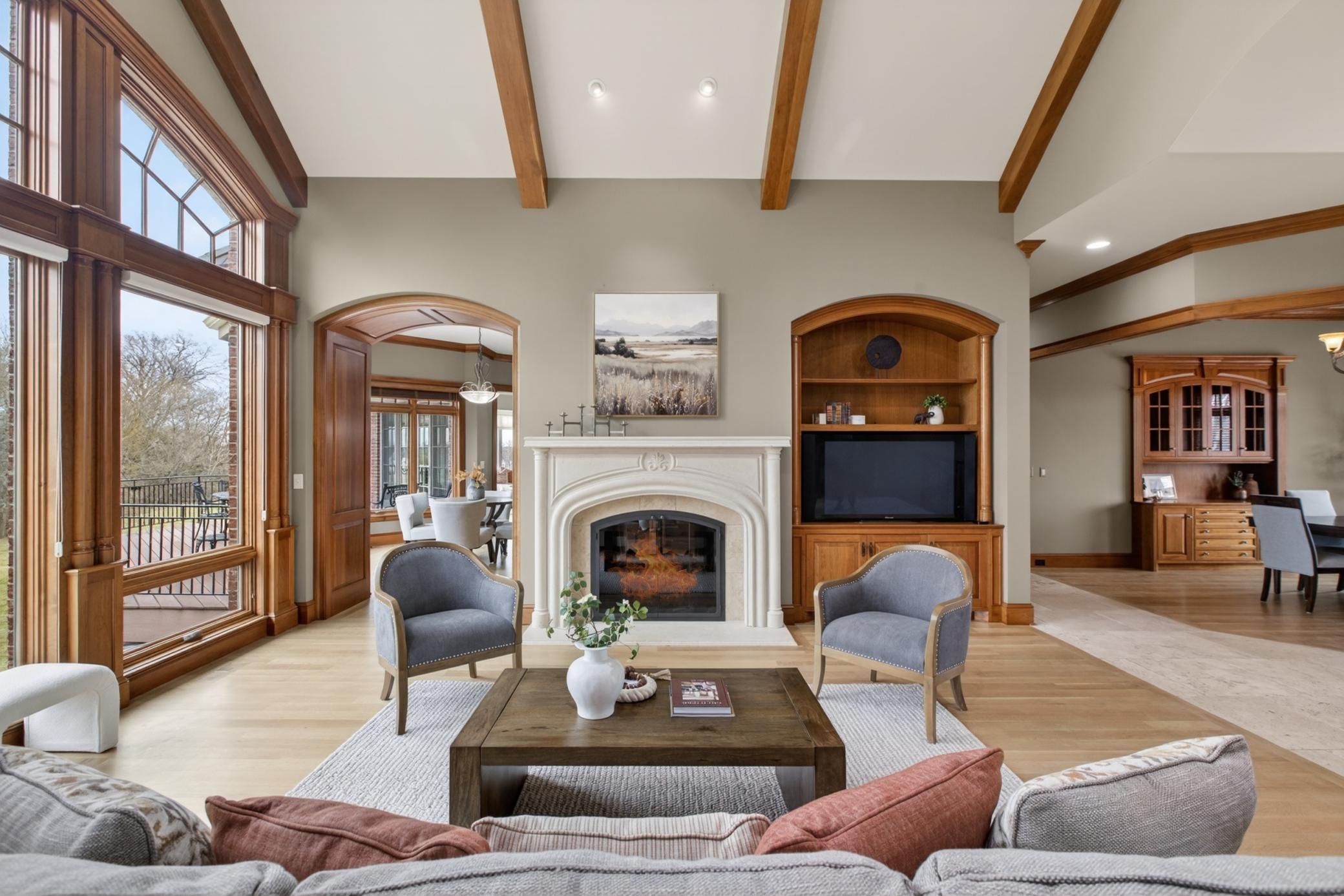 Designed for luxury living, the open-concept great room combines vaulted ceilings, expansive windows, and seamless entertaining spaces.