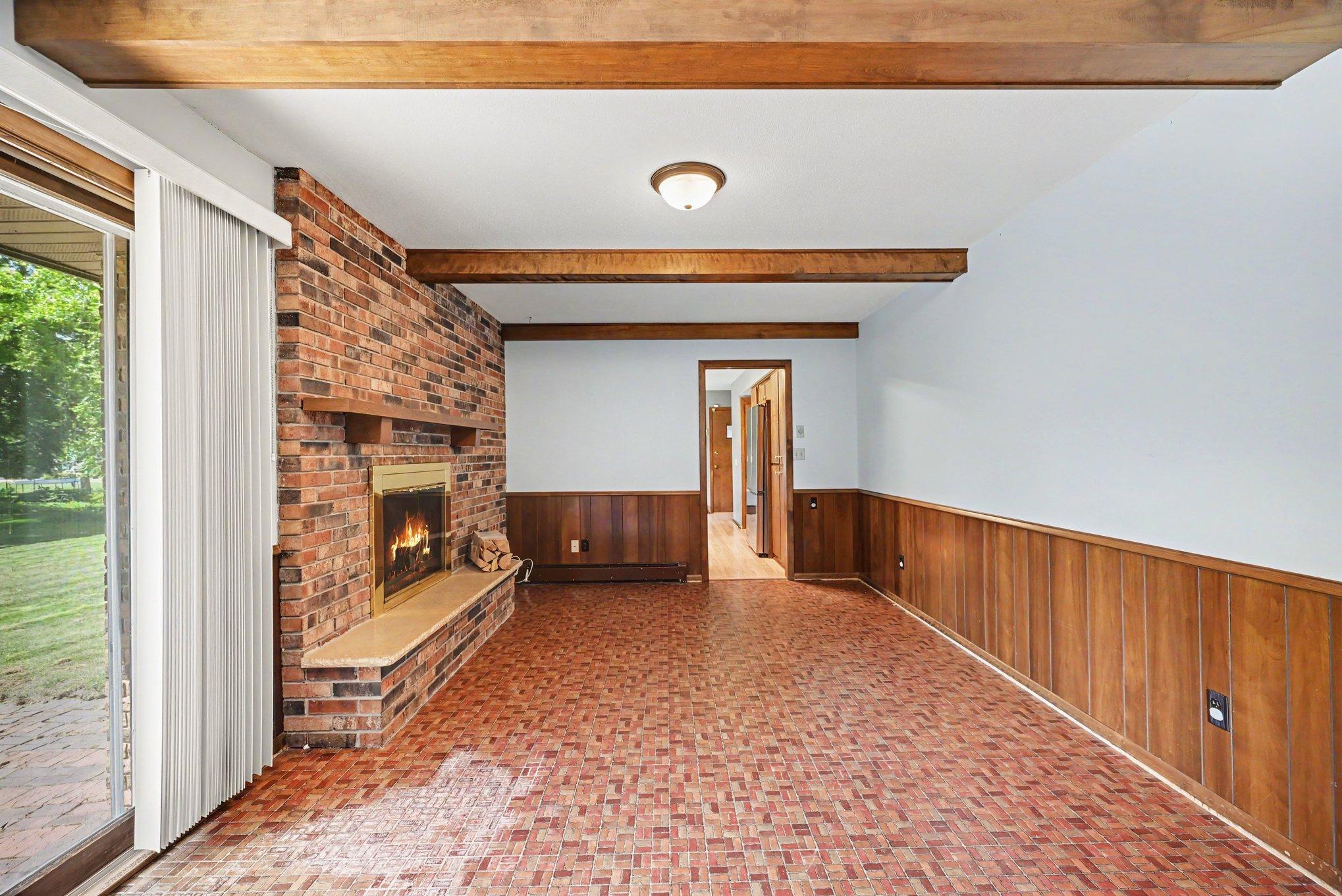 Den with woodburning fireplace