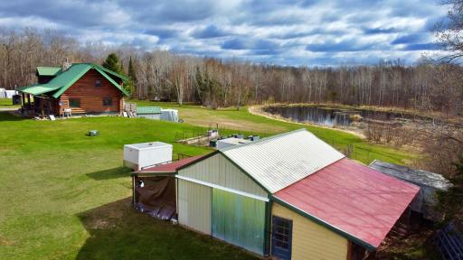 Aerial view of property with pond and outbuilding.jpg