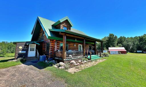 Main side view of Log Cabin and acreage in the distamce.jpg