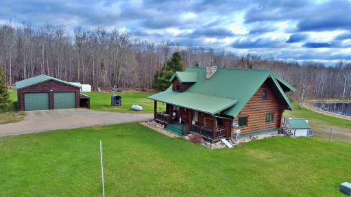 Propety view of log home garage and pond.jpg