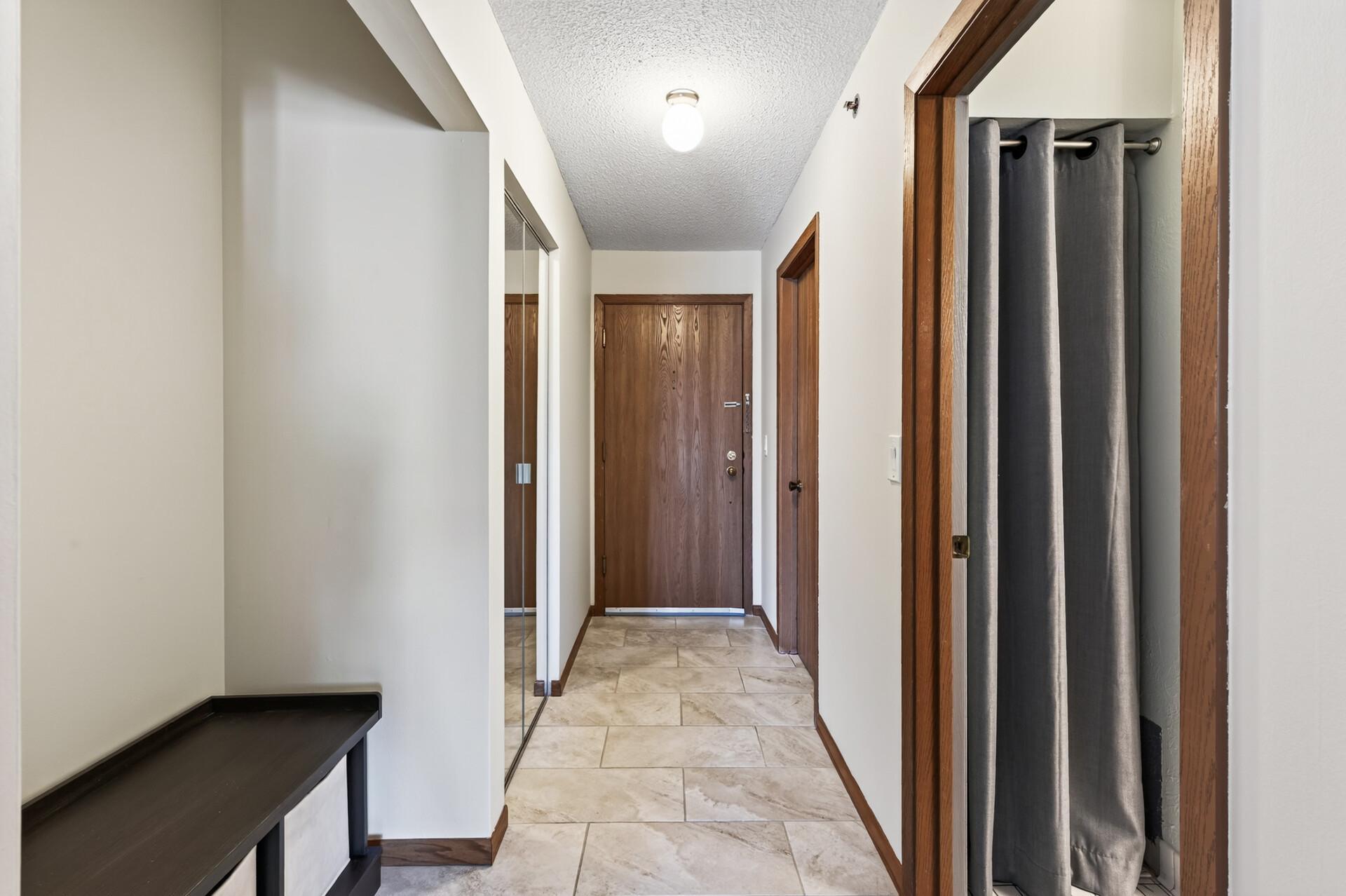 Entryway with hall closet and storage room