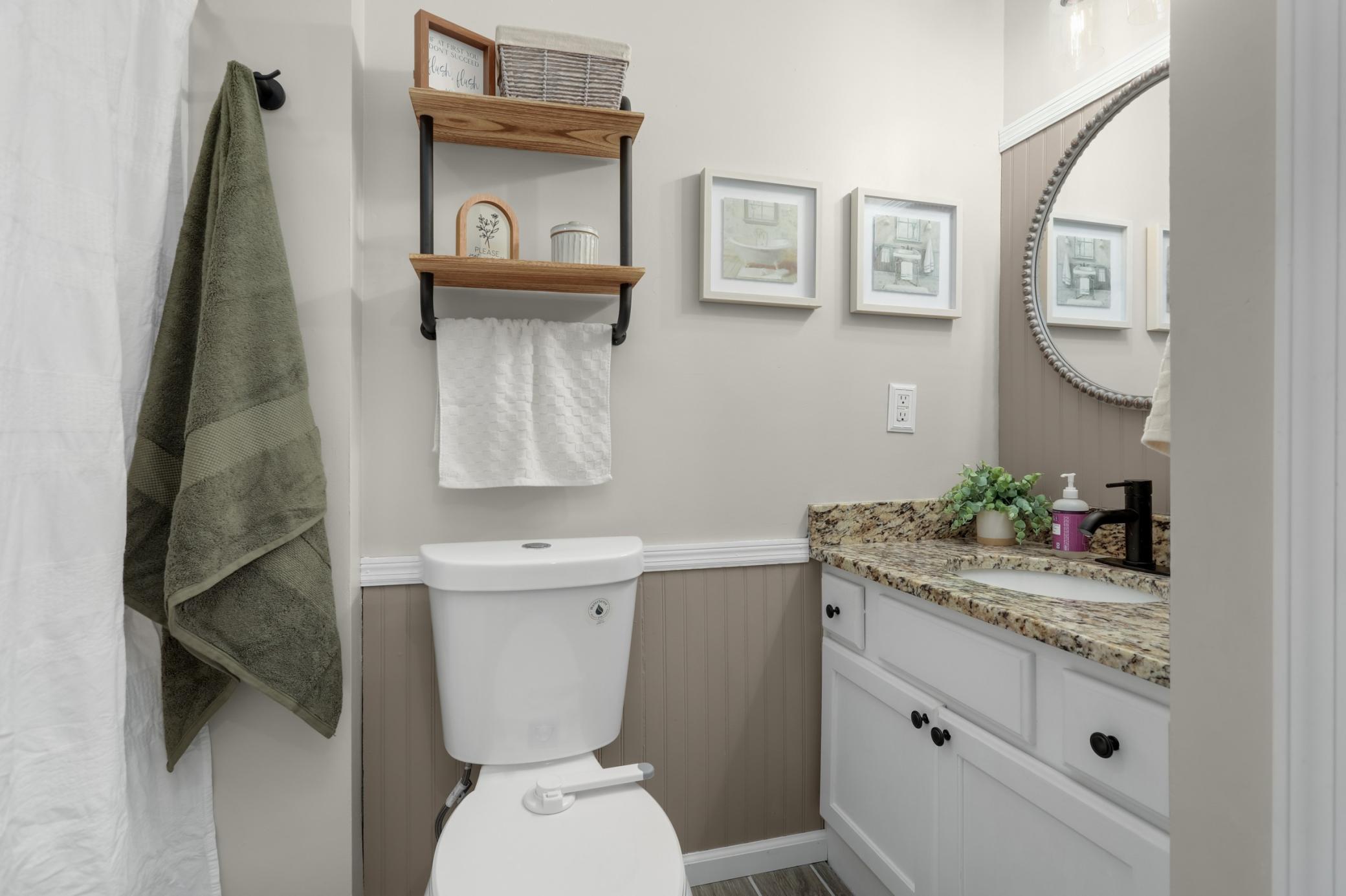 Full main floor bathroom featuring granite countertops.