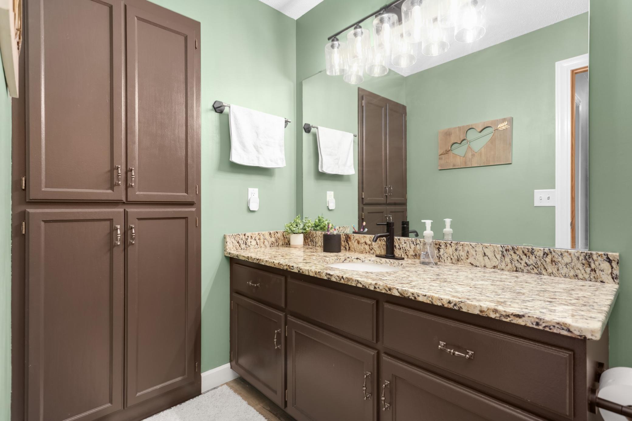 Full upper-level bathroom with ample storage space.