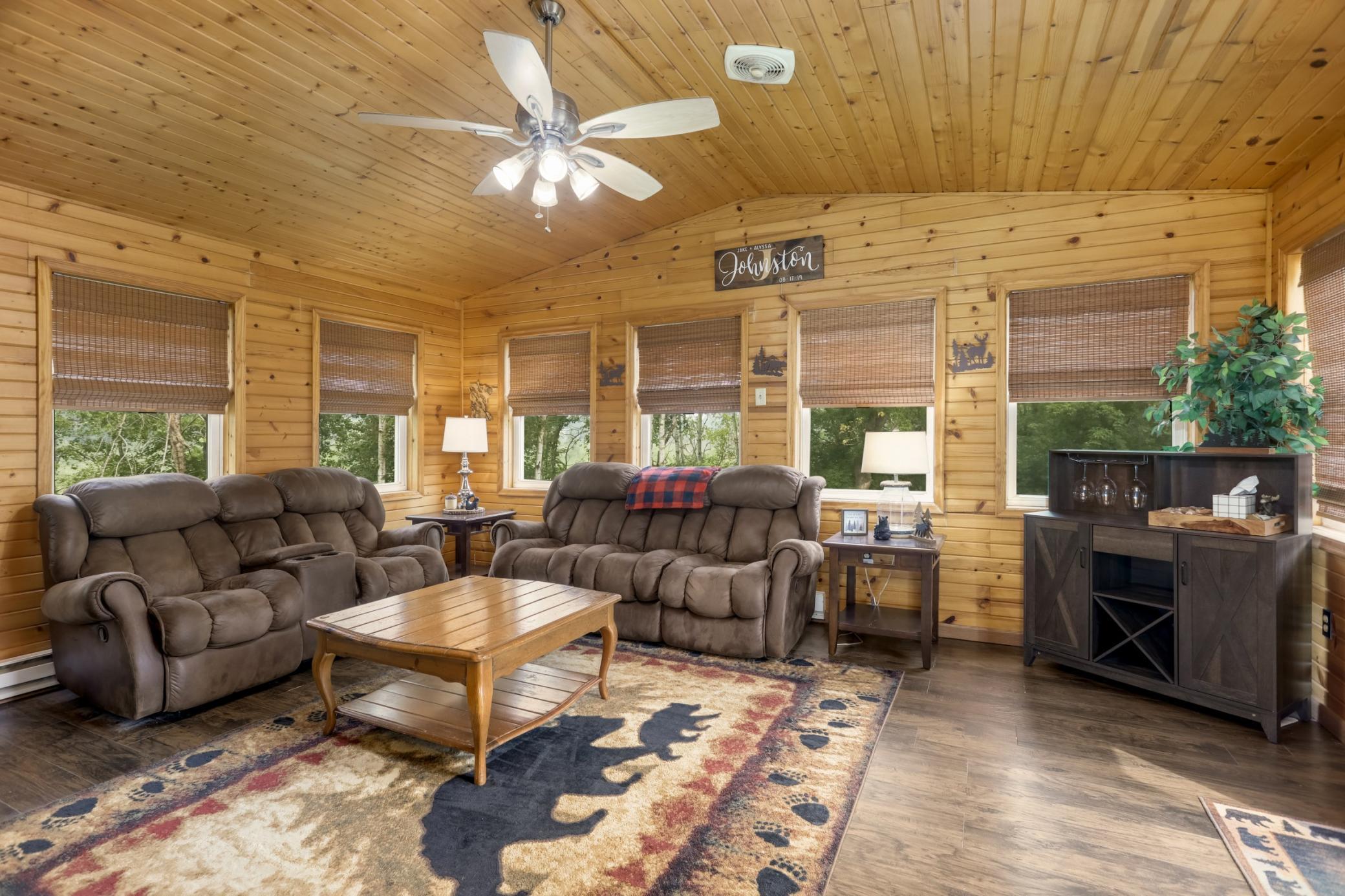 Stunning four-season porch featuring vaulted knotty pine ceilings and walls, filled with abundant natural light.