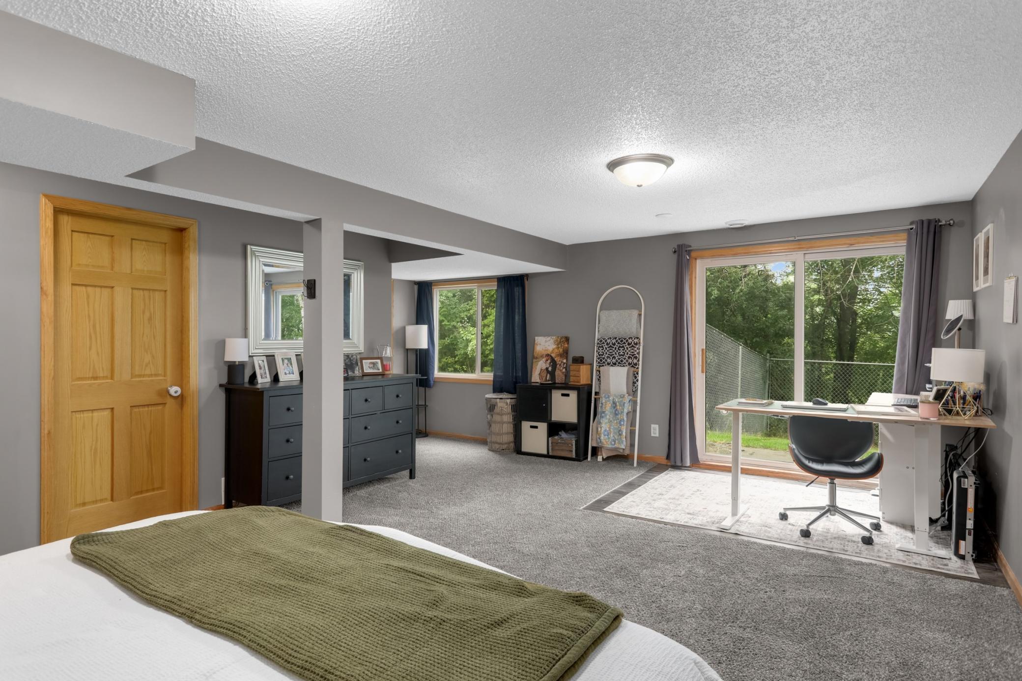 Walkout lower level bedroom with direct access to the fully fenced backyard.