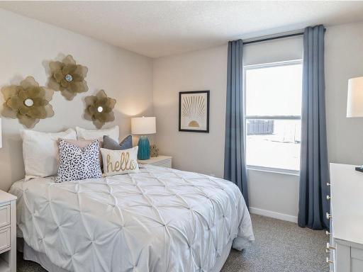 Second bedroom with white bed and white nightstands.