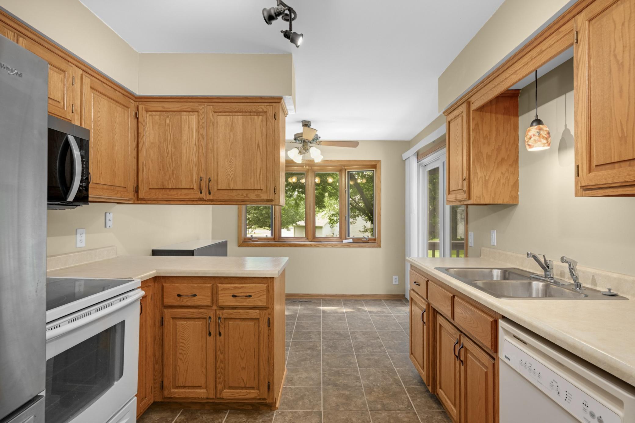 Beautiful oak cabinets and newer appliances. Micowave 1 year old Patio door leads to spacious deck to enjoy the wooded backyard area.
