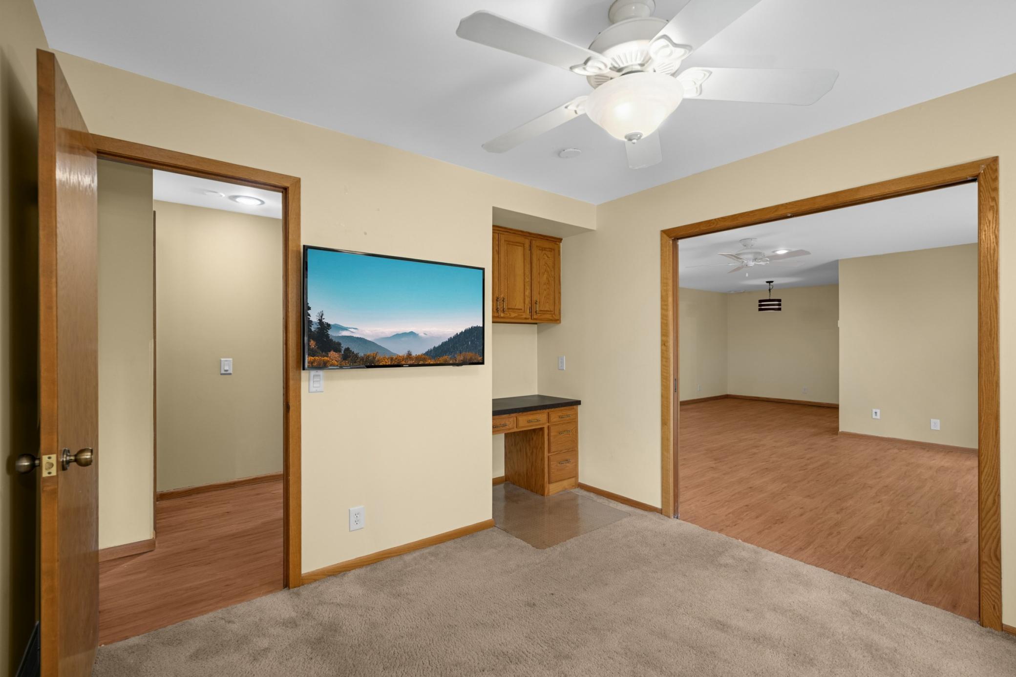 Den with built in desk. This could be used as a office or 3rd bedroom. Tv's included