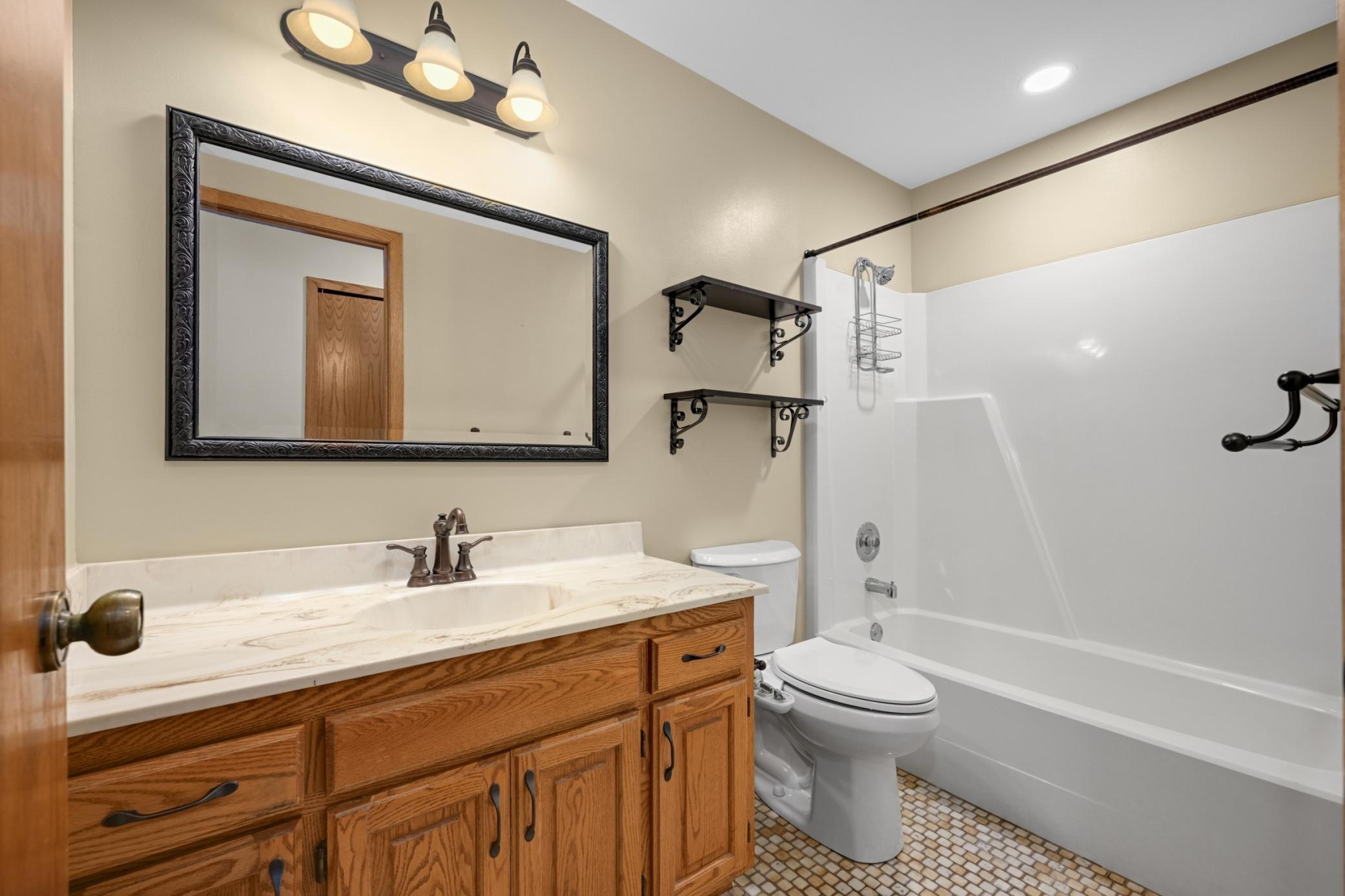 Nice spacious full guest bath ceramic flooring. Recess lights new 3 years ago approx. Toilet replaced in 2025.
