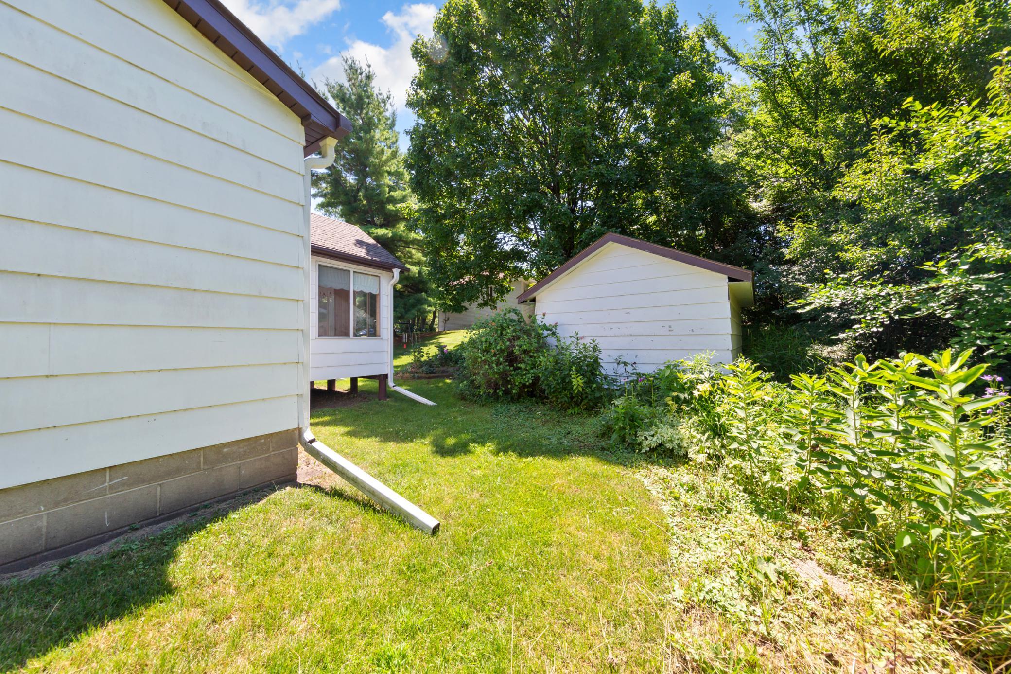 Side yard, property also has 2 storage sheds