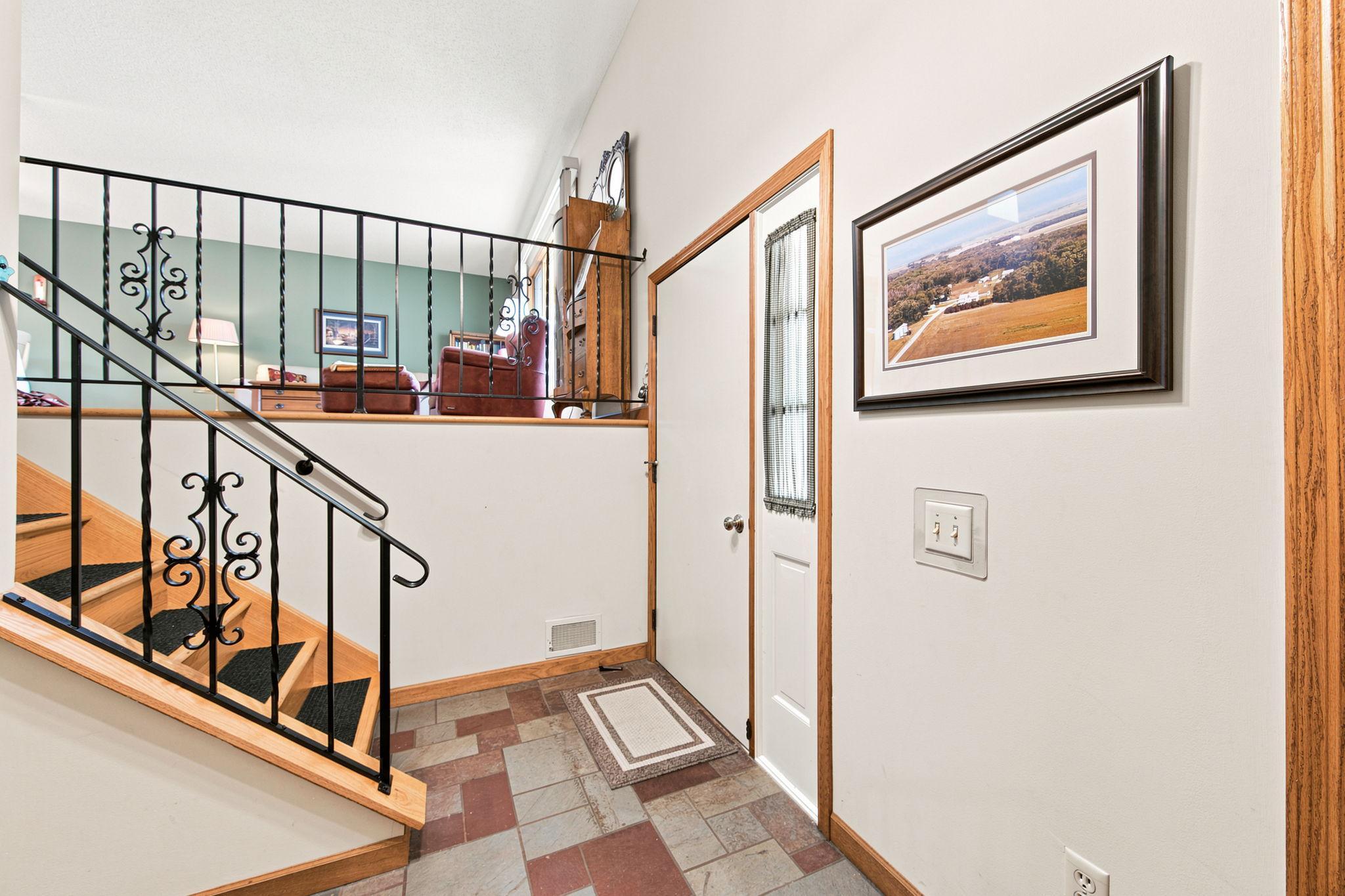 Spacious tiled entryway with large coat closet.