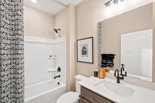 Bathroom located off foyer next to bedroom